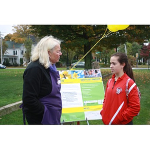 Women stand in front of poster at Marathon Daffodils event