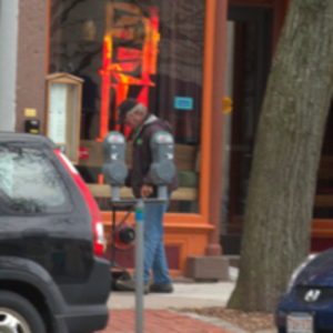 Man sweeping sidewalk at dawn