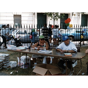 Two women staffing an information table at Festival Betances 1999.