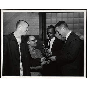 Two men receive a trophy in the 1963 Boys' Clubs of Boston Basketball Tournament