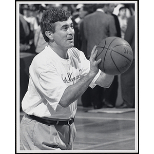 Paul Cellucci, former Massachusetts governor and U.S. ambassador to Canada, preparing to shoot a basketball at a fund-raising event held by the Boys and Girls Clubs of Boston and Boston Celtics