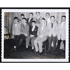 Ten Boys' Club members in suits posing for a group picture