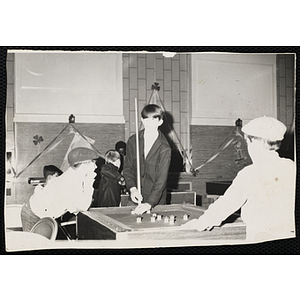 Group of boys playing at a bumper pool table