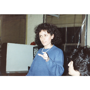 Woman addresses Chinese Progressive Association members at a meeting