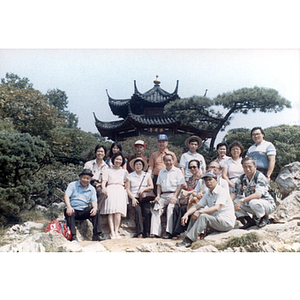 Association members gather in a Chinese park in front of a gazebo