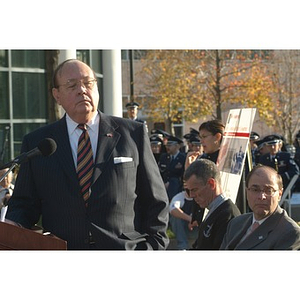 Richard Egan at the podium at the Veterans Memorial dedication ceremony
