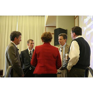 Five people stand and converse together at the Training Future Innovators Entrepreneurs Panel