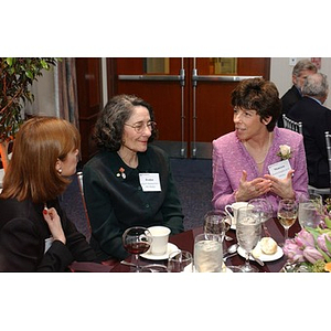 Three women converse at The National Council Dinner