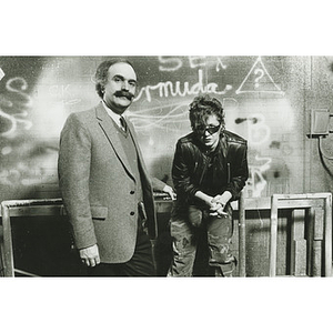 Sociology professor Jack Levin a woman standing in front of a graffitied wall