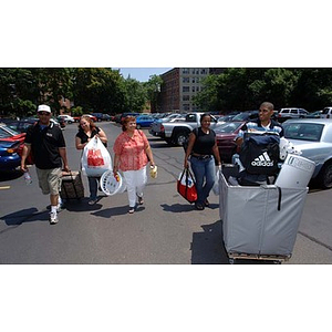 Several people assist Ana Hidalgo during Torch Scholars move-in