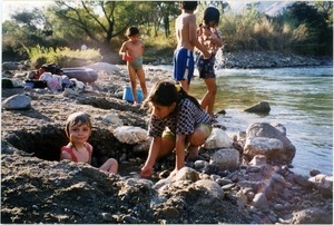 Granddaughter of Sebastian Mutas Ventura washing Maya in hot springs beside Rio Blanco