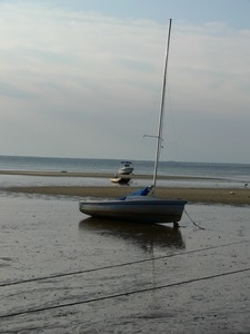 Sailboat hauled onto a mudflat at low tide