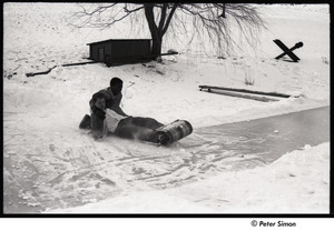 Party at Jackie Robinson's house: boys riding sled