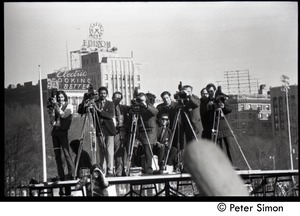 Press covering the protest from atop a platform