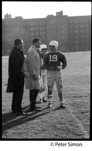 Coach talking to a player on the field