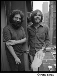 Jerry Garcia (left) and Bob Weir of the Grateful Dead standing on a balcony