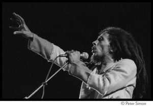 Bob Marley in concert, gesturing to the audience