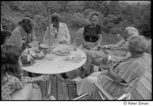 Ram Dass and dad at mum's: Ram Dass, Phyllis Alpert, Andrea Simon, George Alpert, unidentified, Ronni Simon, and unidentified, clockwise from top left, seated on a patio