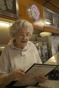 Waitress looking at a menu, Miss Florence Diner