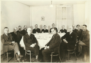Faculty members gathered around a dining table