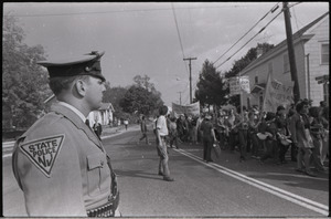 Antiwar demonstration at Fort Dix, N.J.: Police officer watching demonstrators march past