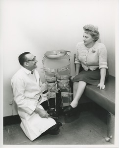 Doctor presenting Mrs. Frances Marsala's with a hip to foot double leg brace