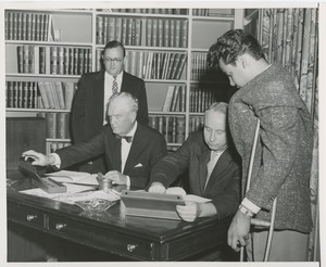 Presidents Bruce Barton of ICD and Carroll V. Newsom of NYU preparing to sign an affiliation agreement