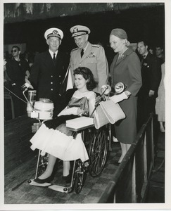 Young woman in wheelchair with others
