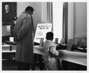 Man and child viewing baseball exhibit, 1959