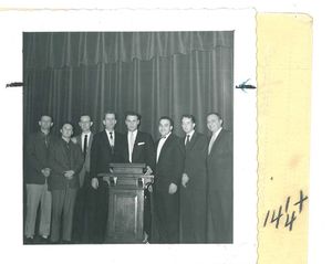 Members of Suffolk University's Veteran's Club standing around podium, circa 1949
