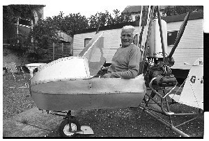 Rex McCandless, Northern Ireland Inventor, posing with small aeroplane that he invented. It is now in the Ulster Folk and Transport Museum