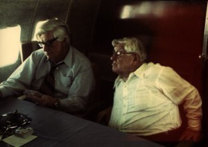 Thomas P. O'Neill playing cards on the airplane with unidentified man