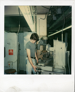 [Student working in machine shop]