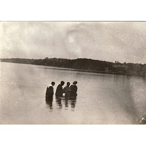 Reverend Dr. Wm. Frederick Fisher performs a baptism in a river