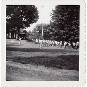 A group of campers salute the American flag at Breezy Meadows Camp