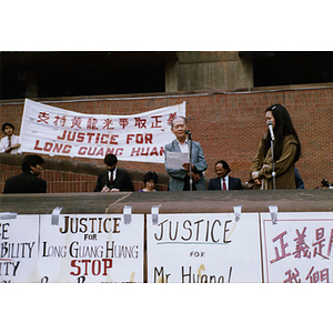 Elderly Chinese man speaking at the rally for Long Guang Huang in City Hall Plaza in Boston