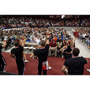 Cheerleaders perform in front of the audience at the President's Convocation