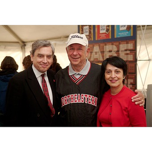 President Freeland and his wife, Maria, pose with a Northeastern supporter before the Homecoming game