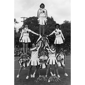 Cheerleaders in formation at homecoming football game