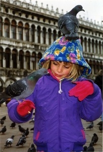 Maya with pigeon on her head in Piazza San Marco on New Years Day