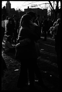 Crowd on Cambridge Common: couple hugging (Sheraton Commander hotel in background)