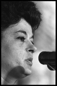 Unidentified woman: close-up portrait, speaking at a podium