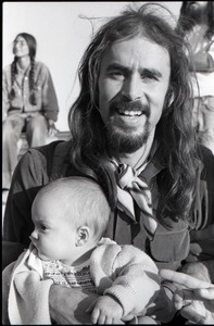 Hollywood Speedway Rock Festival: long-haired man holding infant