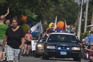 Police escort leading the approaching parade : Provincetown Carnival parade