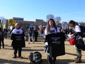 Protesters on the National Mall marching against the War in Iraq, with t-shirts reading 'Stop bitching, start a revolution'