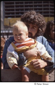 MUSE concert and rally: man holding baby at the No Nukes rally