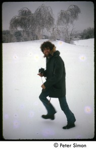 Peter Simon with camera, trudging through the snow after an ice storm, Tree Frog Farm Commune