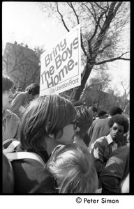 View of the crowd with a sign reading 'Bring the boys home -- Gay Liberation Front'