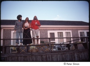 Ram Dass (right), Mirabai Bush, and Daniel Goleman on a beach house deck