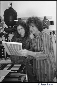 Usha (Cathy Brown) and Peter Simon in a darkroom, next to an enlarger